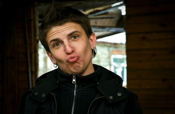 A person with a punk hairstyle making a funny face, maybe in response to breakup-worthy things partners did.