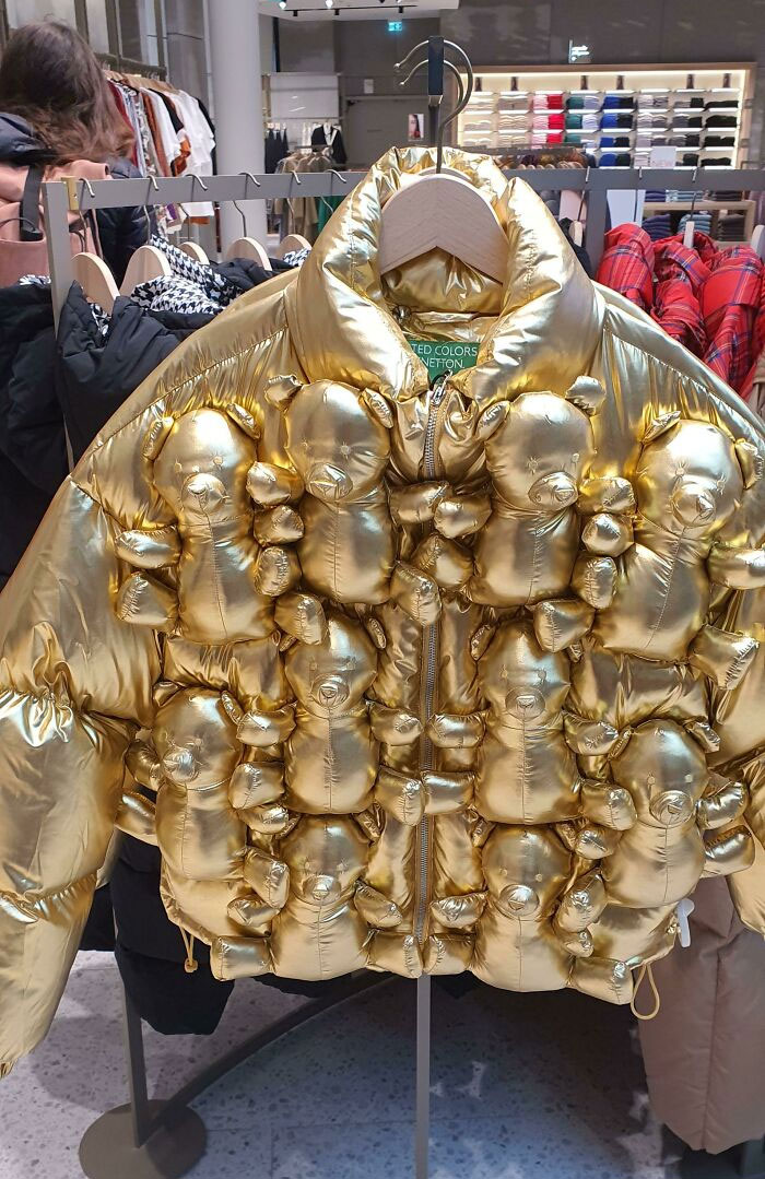 A shiny gold puffer jacket covered in small teddy bears, a hilariously bad fashion crime.