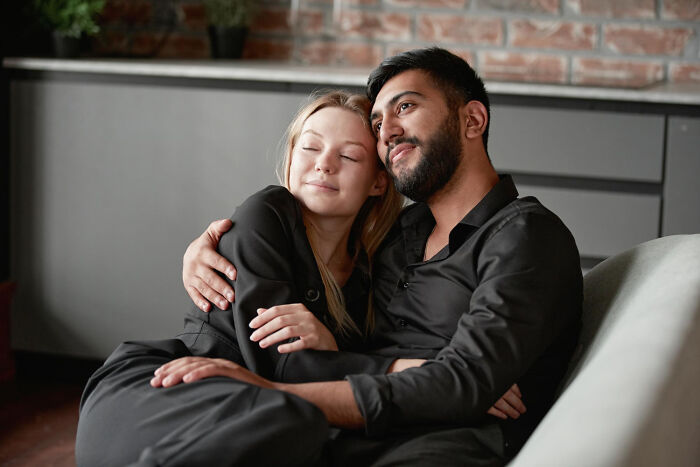 A couple embracing on a couch, illustrating stories about life and what comes after.