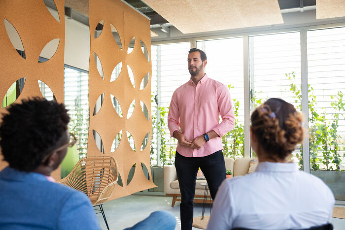 Man presenting to a small group, demonstrating communication skills that genuinely changed his life.