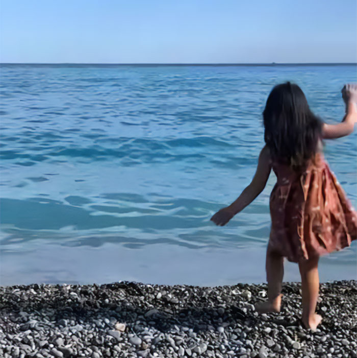 Little girl on beach in France, related to French kids' school lunch comparison with USA. Little girl on beach in France, related to French kids' school lunch comparison with USA.