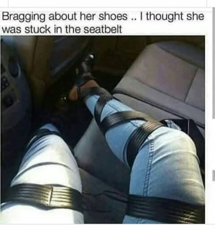 A person's legs in light-wash jeans, appearing to be tightly wrapped with black straps in a car seat, a hilariously bad fashion crime.