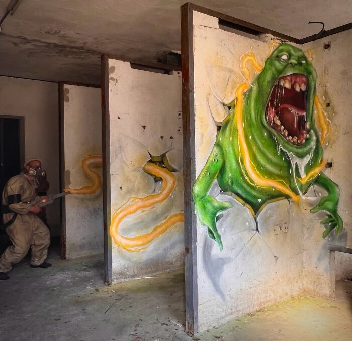 A French artist creates a mind-bending 3D illusion of a ghost on an ordinary wall, with a person in a hazmat suit.