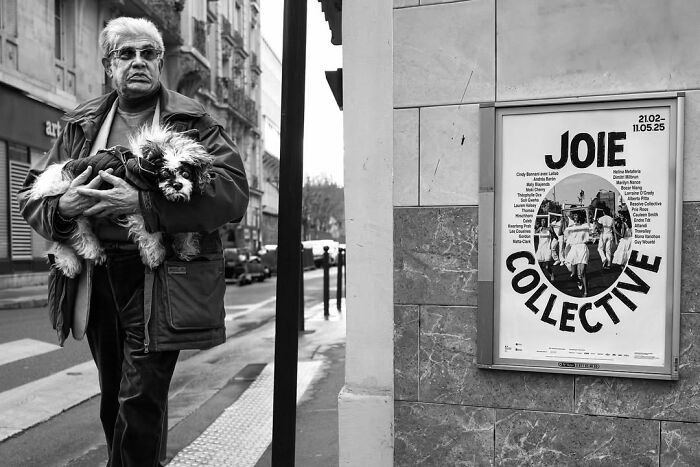 Gaspard Claude's perfectly timed street photos show a man holding his dog, capturing unseen Paris.