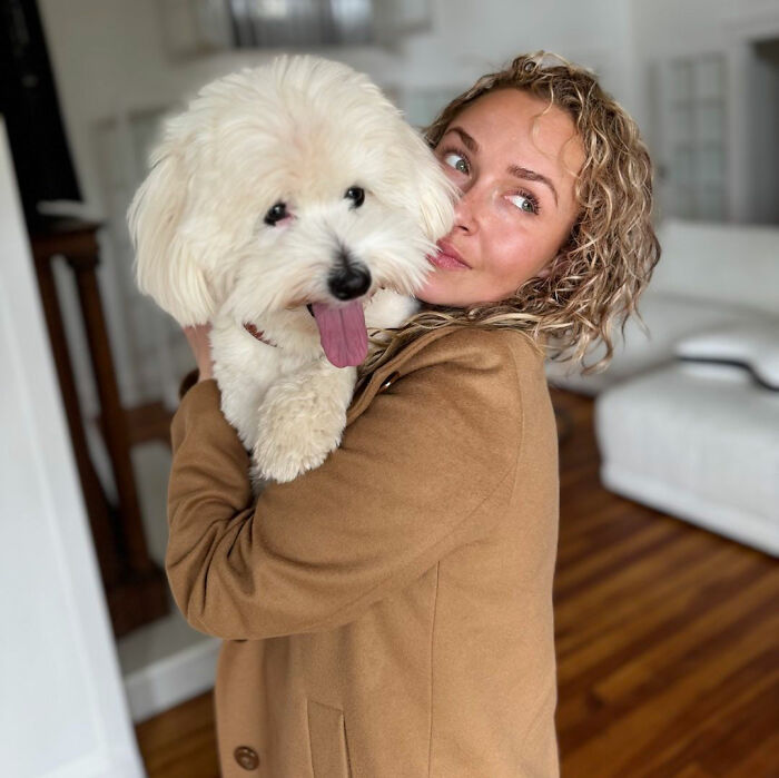 Hayden Panettiere with a dog, reflecting on her childhood history.