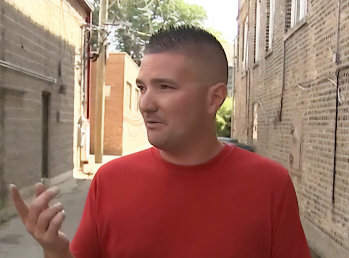 A man, the terrified electrician, standing outside after getting stuck inside a 130ft high sign