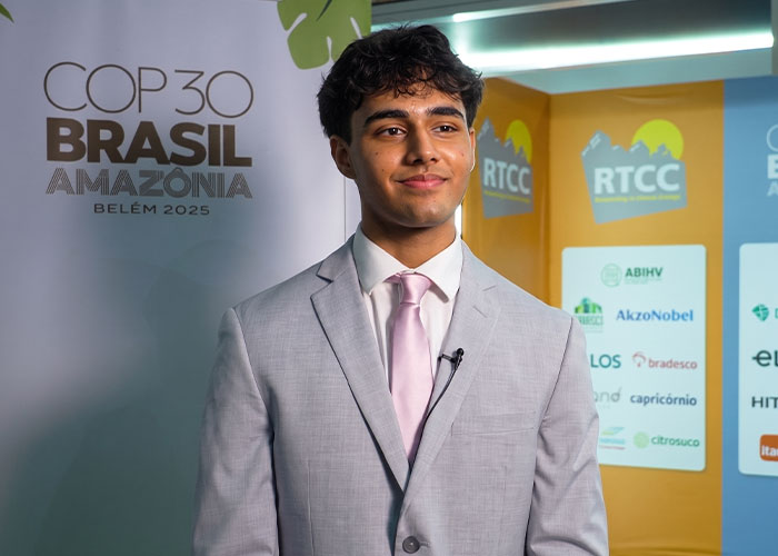 A Florida teenager in a suit smiling, inventing a bee-saving device to increase honey production. A Florida teenager in a suit smiling, inventing a bee-saving device to increase honey production.