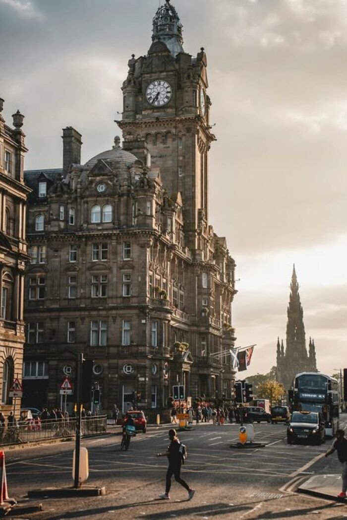 Historic clock tower building in a bustling city street, a prime example of iconic building character.