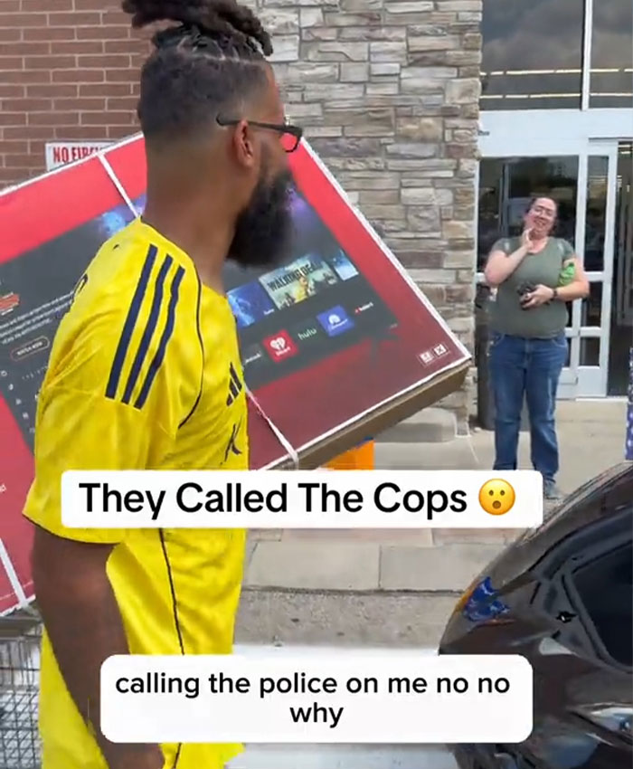 Influencer leaving Walmart with a large TV, stating they called the cops, after being banned from buying groceries.