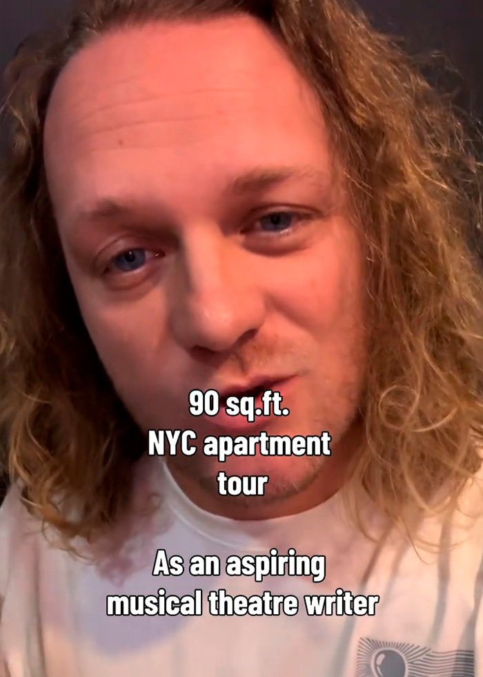 A man with long curly hair, a theatrical writer, is starting an NYC apartment tour of his 90-square-foot living space. A man with long curly hair, a theatrical writer, is starting an NYC apartment tour of his 90-square-foot living space.