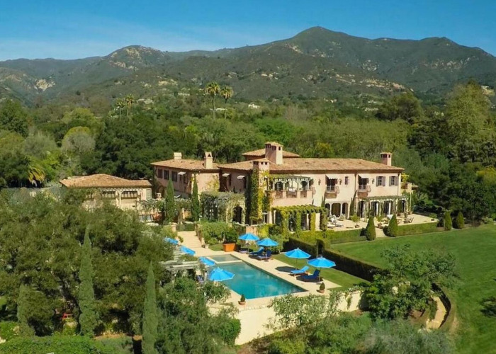 Aerial view of Meghan Markle and Prince Harrys former US home, a grand estate with a pool and lush mountains.