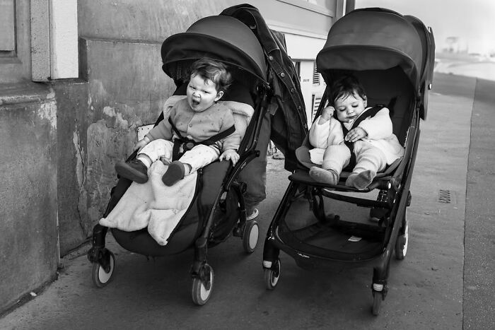 Two babies in strollers in black and white, perfectly timed street photos revealing unseen Paris life.