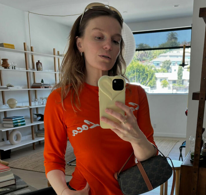 The Black Mirror director, Kate Herron, takes a mirror selfie, showing her style and persona.