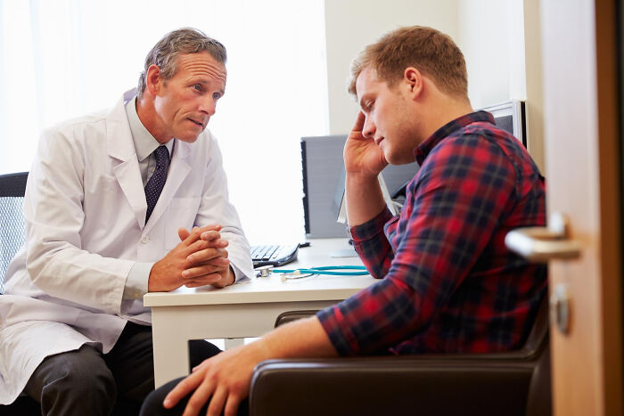 A doctor speaks to a distressed patient. Doctors reveal the diagnoses that were the hardest to deliver.