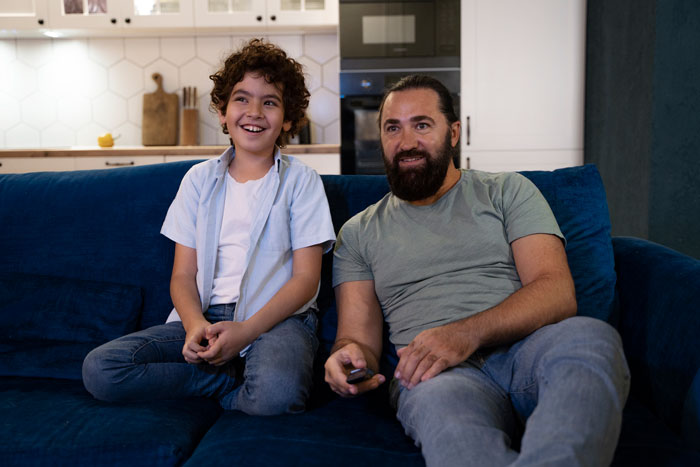 Father and son on a couch, a real deal moment from the universe.