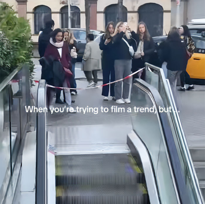 A metro station escalator with a group of women filming nearby, blocked by tape, illustrating the metro station hero situation. A metro station escalator with a group of women filming nearby, blocked by tape, illustrating the metro station hero situation.