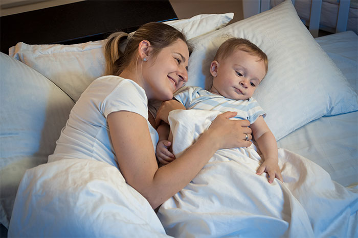 Mother and baby in bed, highlighting wife's decision to defend her marital bed.