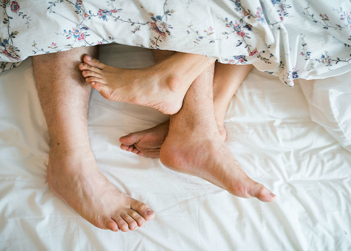 Feet of a couple in bed, suggesting intimacy alive through the 72-hour rule. Feet of a couple in bed, suggesting intimacy alive through the 72-hour rule.