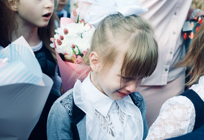 A young girl crying, possibly witnessing or experiencing shameful moments at weddings.