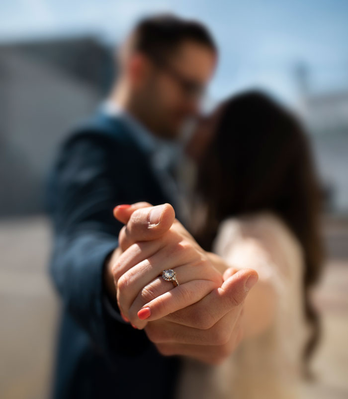 Blurred image of a couple holding hands, focusing on an engagement ring. This illustrates control in marriage. Blurred image of a couple holding hands, focusing on an engagement ring. This illustrates control in marriage.