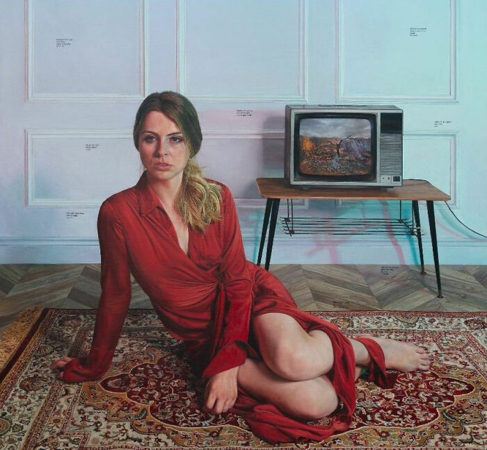 A hyperrealist painting by Ian Cumberland depicting a woman in a red dress sitting on a rug with a vintage TV.