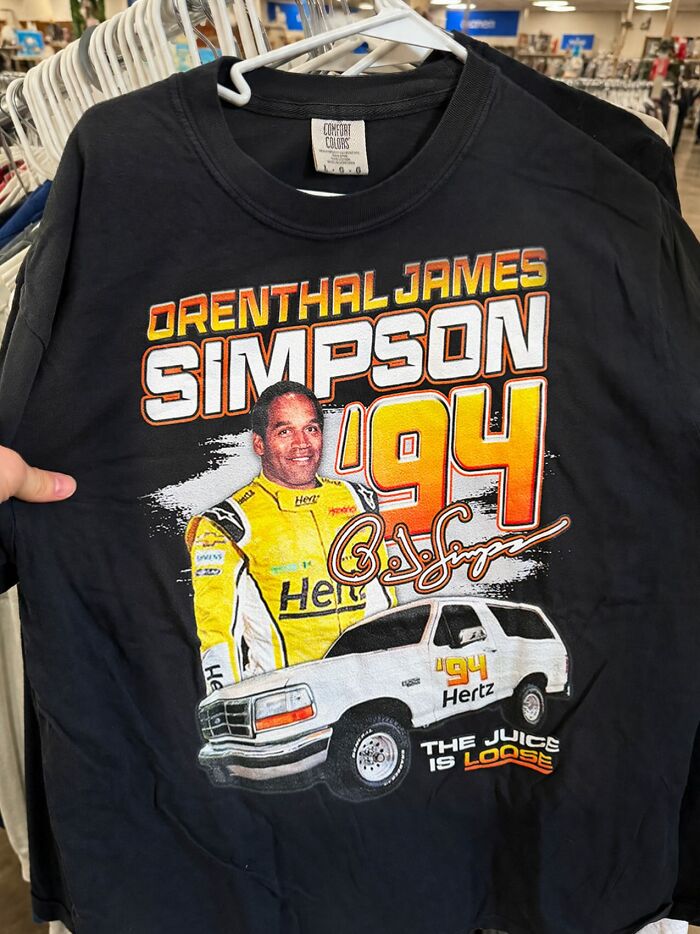 A black shirt featuring an iconic shirt design of O.J. Simpson, with a race car and the text The Juice is Loose.