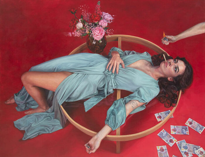 Hyperrealist paintings by Ian Cumberland: a woman reclining on a circular frame with flowers, money, and a lit cigarette.