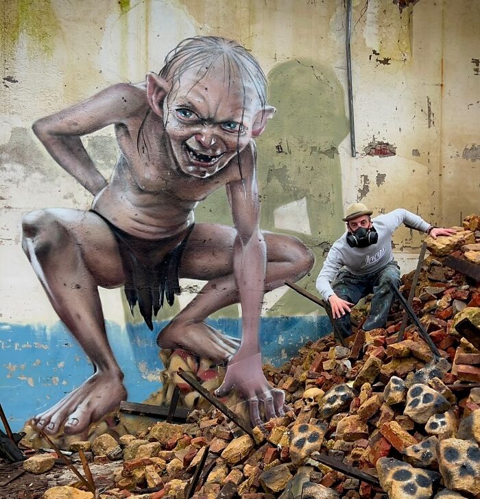 French artist creating a mind-bending 3D illusion of Gollum on an ordinary wall, with debris in foreground.