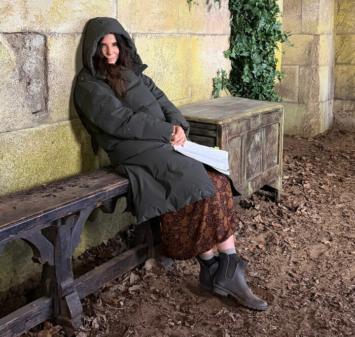 Sandra Bullock bundled up on set, reflecting after her partner's tragic passing. Sandra Bullock bundled up on set, reflecting after her partner's tragic passing.