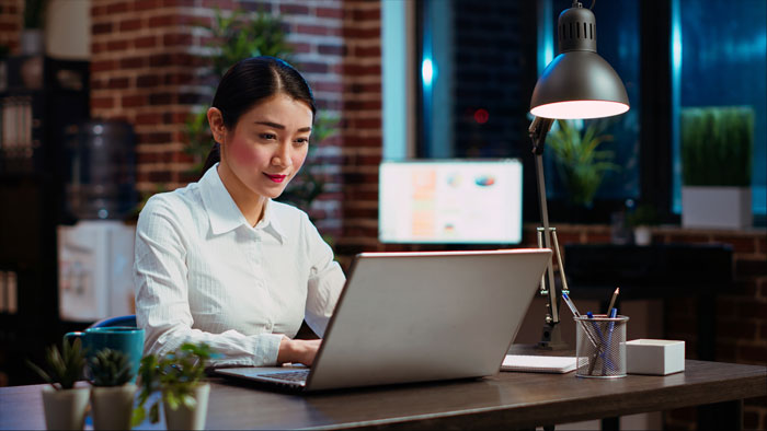 A woman works on a laptop, facing the costly price after donating a kidney to her sick mom. A woman works on a laptop, facing the costly price after donating a kidney to her sick mom.