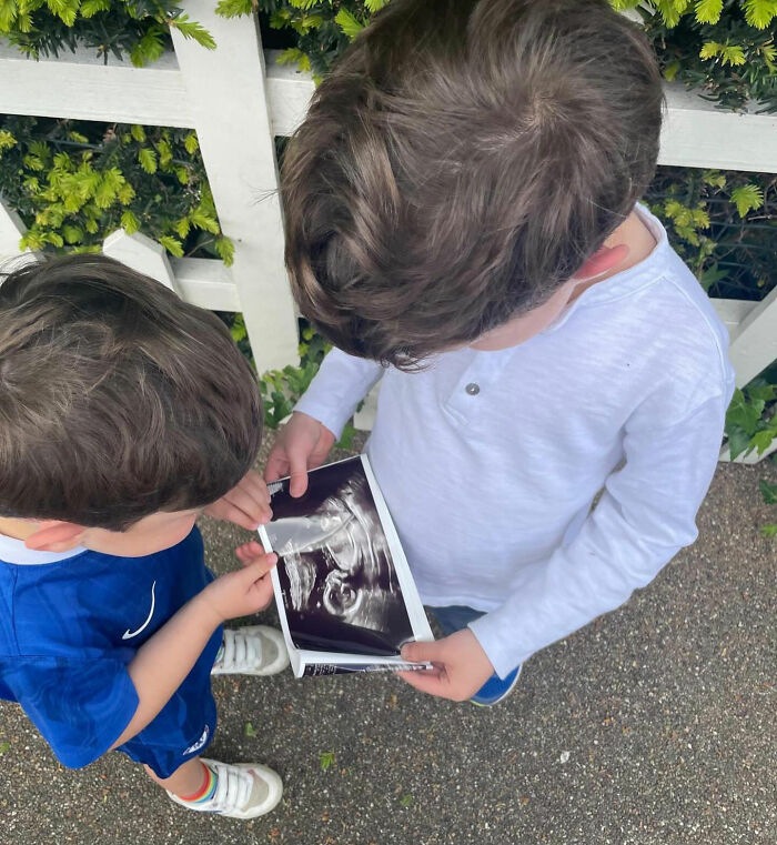 Two young boys look at a baby ultrasound image, sharing news on Eugenie's birthday amid Meghan Markle karma. Two young boys look at a baby ultrasound image, sharing news on Eugenie's birthday amid Meghan Markle karma.