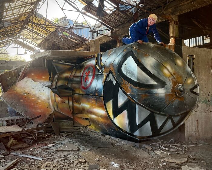 French artist creating mind-bending 3D illusions: A man on a large b**b-like object in a dilapidated building.