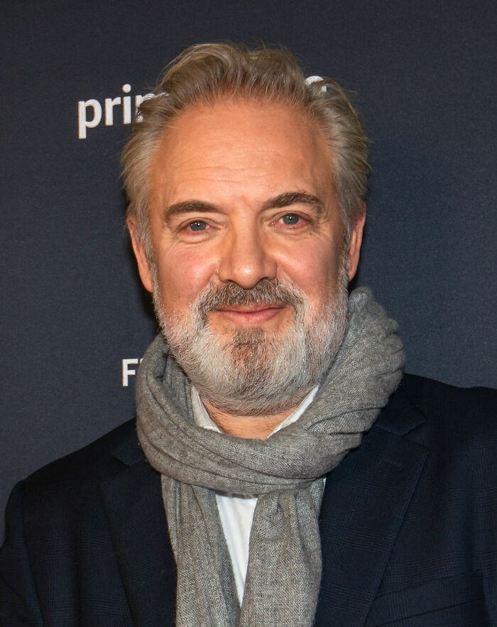 Sam Mendes, a distinguished filmmaker, poses for a photo, showcasing his iconic career highlights.