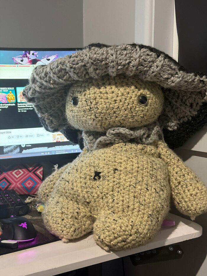Handmade crochet doll with a large hat displayed as a creative crochet project