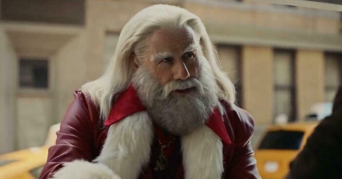 A modern Santa Claus with long white hair and a beard, wearing a red leather jacket, from commercials people cant stand.
