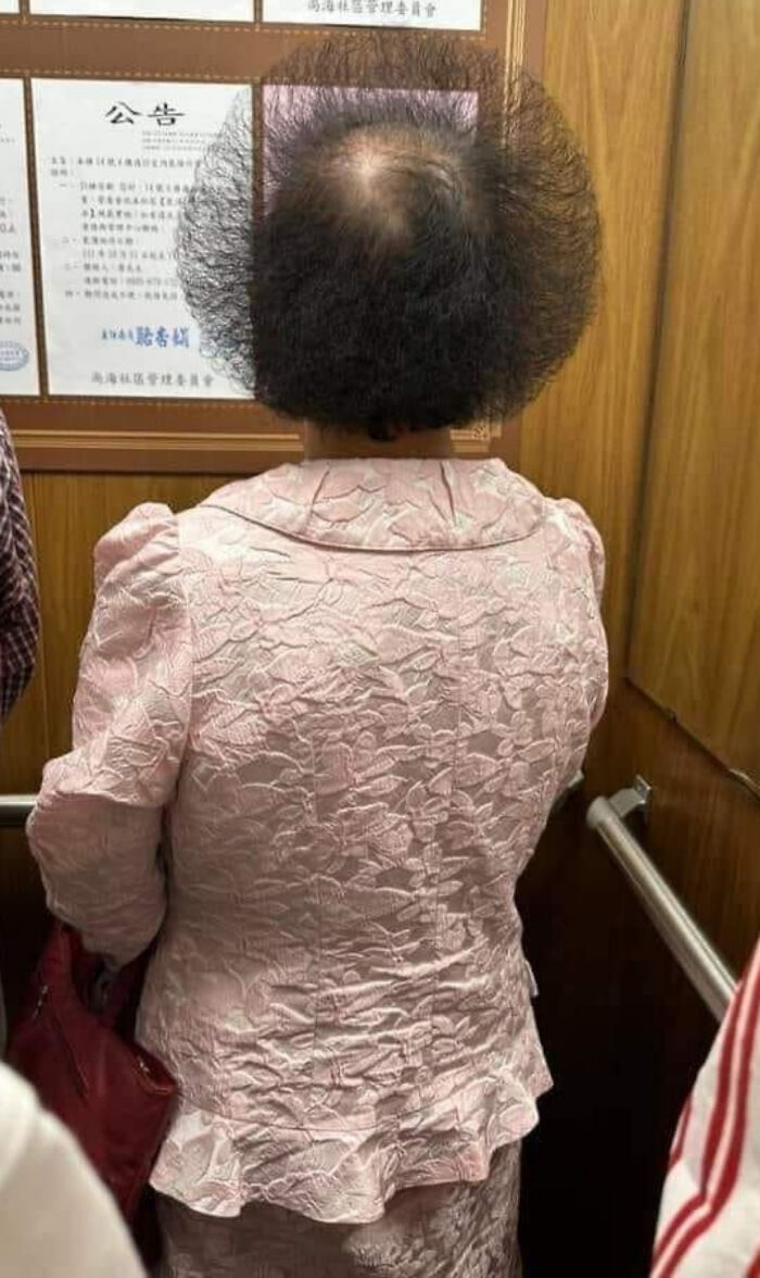 A woman with a unique, geometric hairstyle, highlighting bold hairstyles.