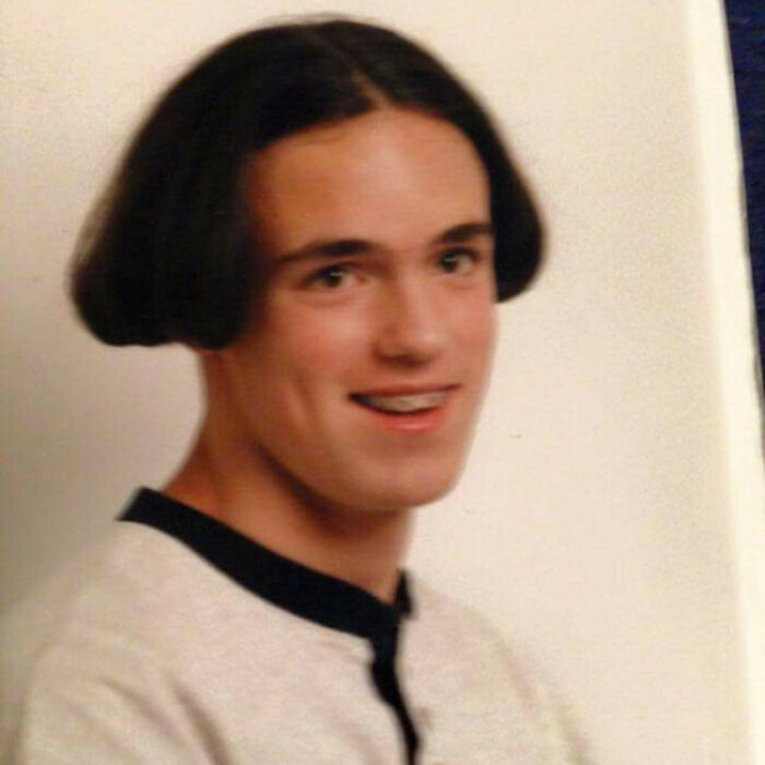 A young man with a bowl cut, demonstrating bold hairstyles.