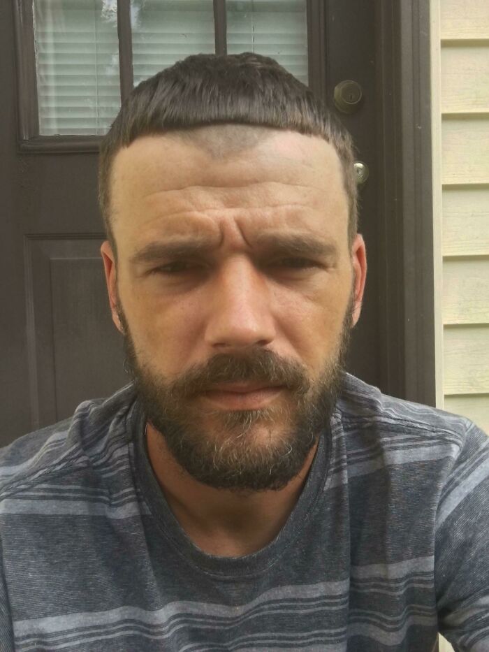 Man with an extreme bowl cut and beard, showcasing one of many bold hairstyles that are certainly unique.