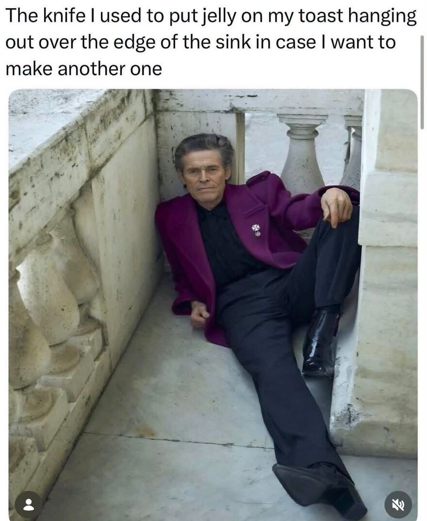 Willem Dafoe in a purple suit, leaning against a wall, as a hilarious meme taking inspiration from real life.