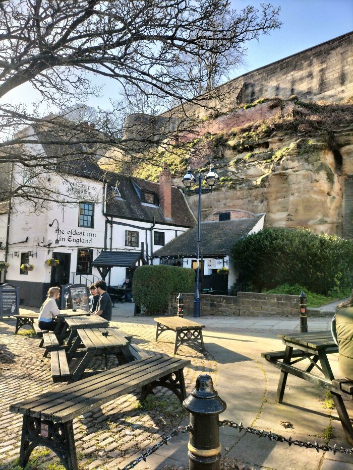 The Oldest Inn in England, a historic pub with outdoor seating, showcasing the captivating Middle Ages.