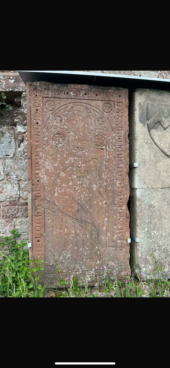An ancient carved stone slab depicting a figure, offering a glimpse into the Middle Ages' human history.