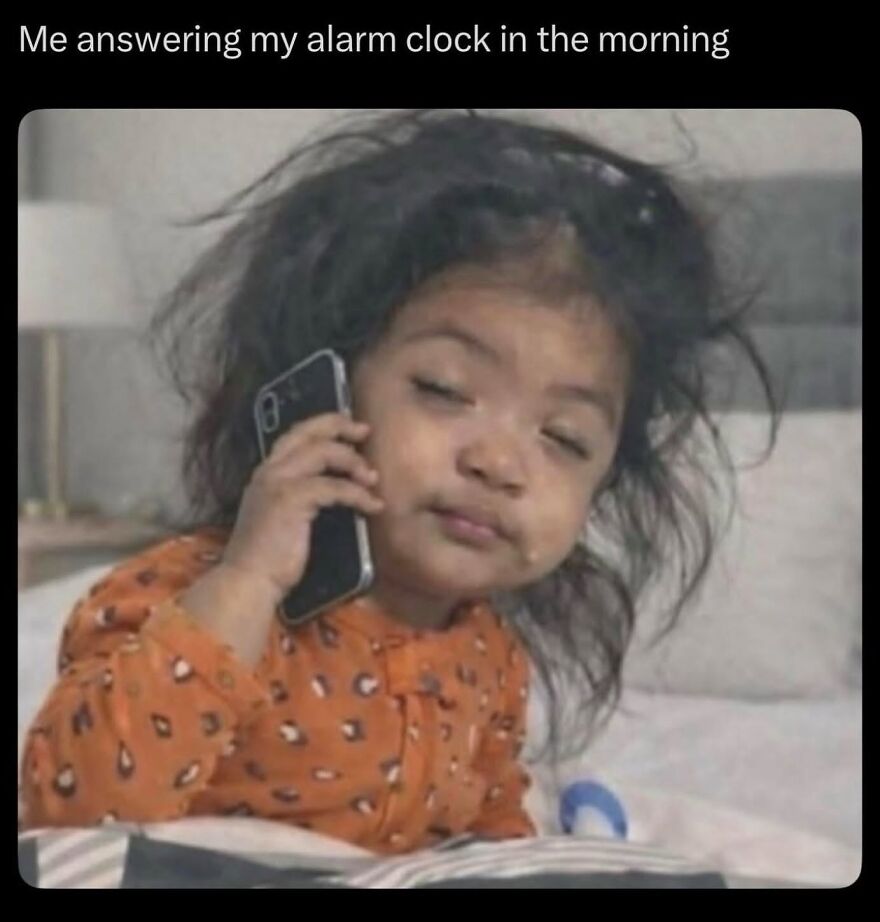 A young child with messy hair and sleepy eyes holding a phone to their ear, a relatable real life meme.