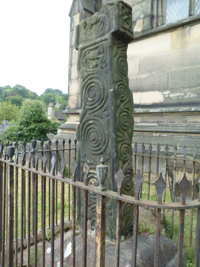Ancient stone cross with elaborate spiral carvings, an artifact from the fascinating Middle Ages.