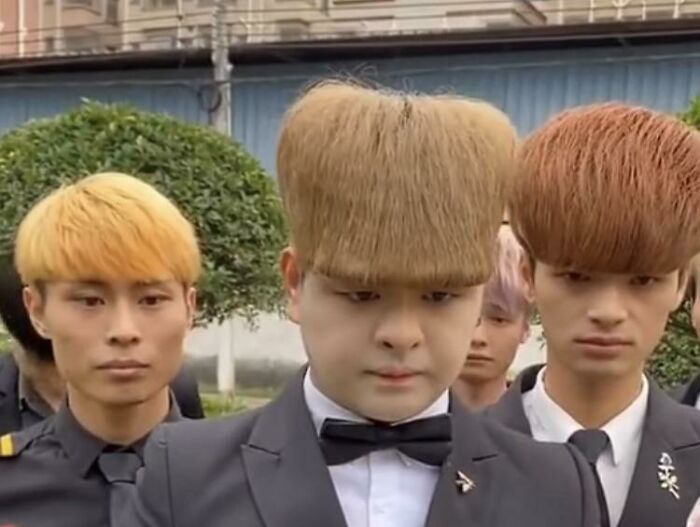 Three men with unusual, rectangular and bowl-cut hairstyles, highlighting bold hairstyles.
