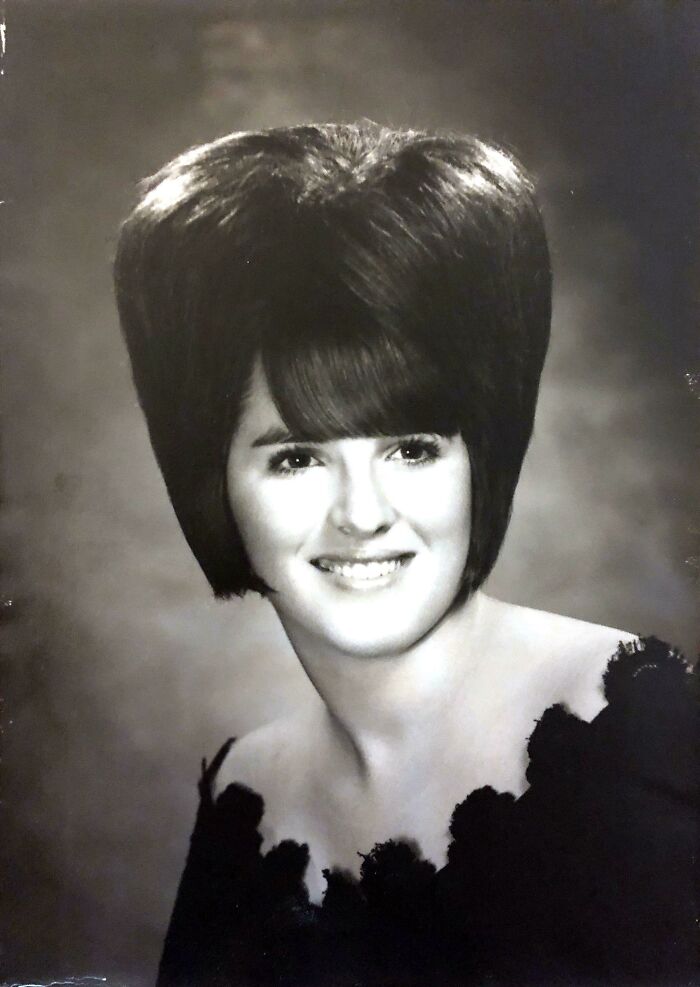 Black and white portrait of a woman with a towering, voluminous hairstyle, showcasing bold hairstyles.