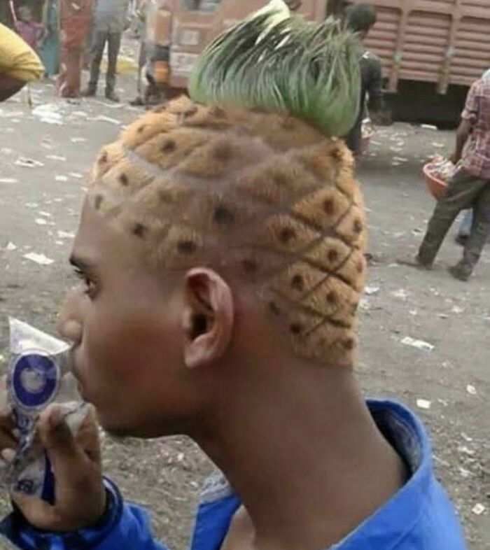 A man with a unique pineapple hairstyle, featuring a textured pineapple skin design and green leafy top.