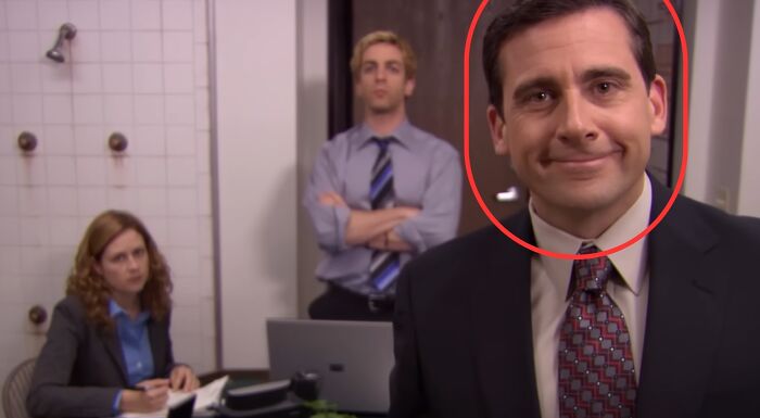 Michael Scott smiles at the camera, with Pam and Ryan in the background. What is Michael Scott's profession?