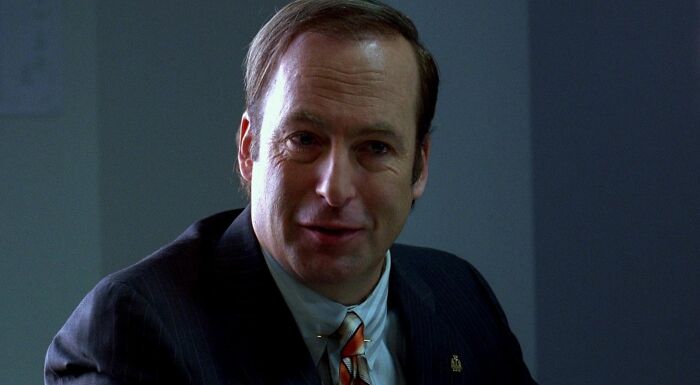 Saul Goodman in a suit and tie, smiling, from Match The TV Show Character To Their Profession.