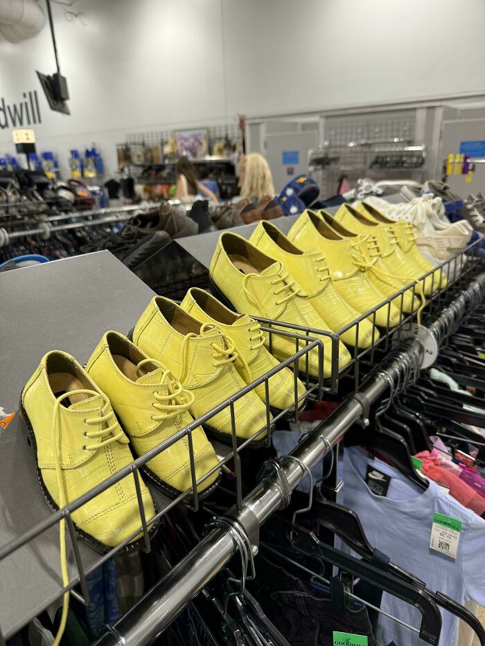 Rows of bright yellow oxford shoes displayed on a rack, a unique jackpot found at the thrift store.