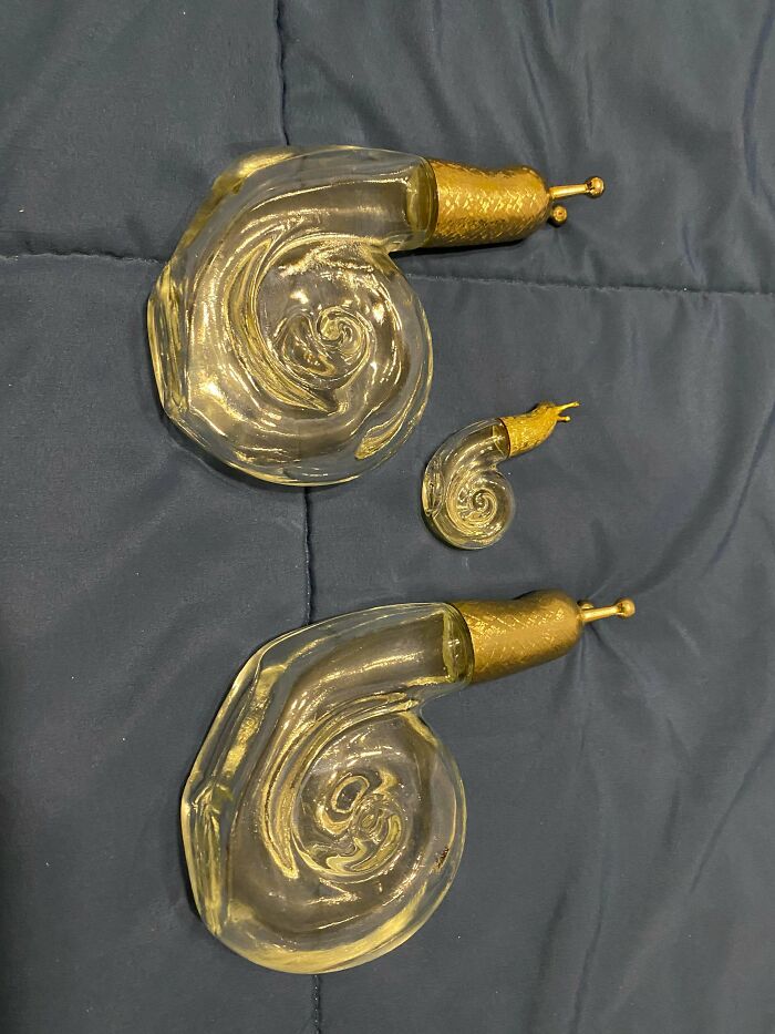Three vintage snail-shaped glass perfume bottles with golden caps, a delightful jackpot from the thrift store.